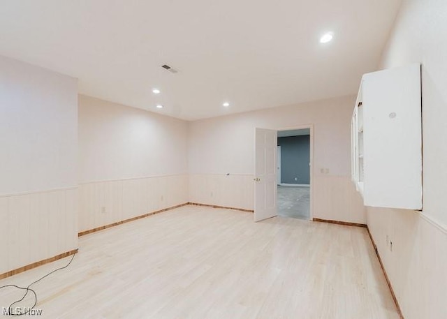 unfurnished room with light wood-type flooring