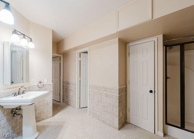 bathroom with tile walls