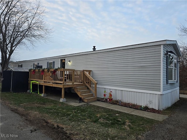 rear view of house with a wooden deck