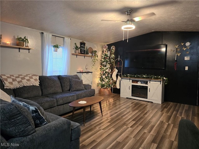 living room featuring hardwood / wood-style flooring, ceiling fan, a textured ceiling, and vaulted ceiling