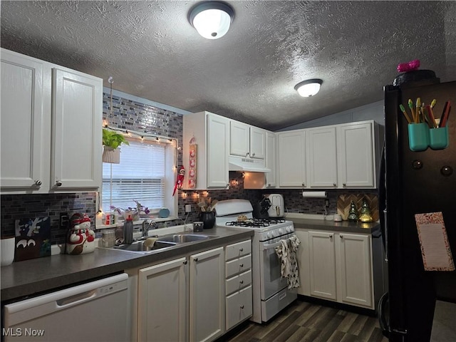 kitchen with tasteful backsplash, white appliances, dark wood-type flooring, sink, and white cabinets