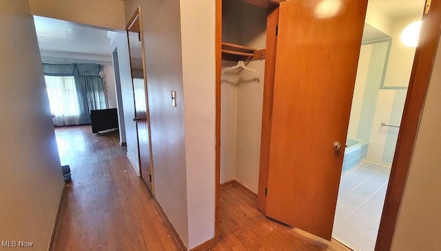 corridor with hardwood / wood-style floors