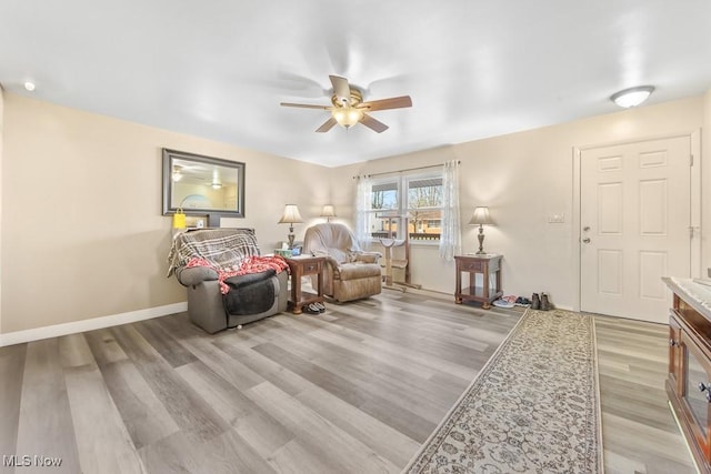 living area featuring ceiling fan and light wood-type flooring