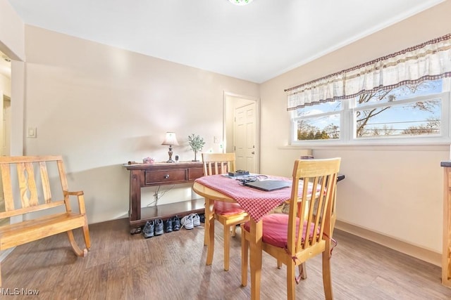 dining space with hardwood / wood-style floors