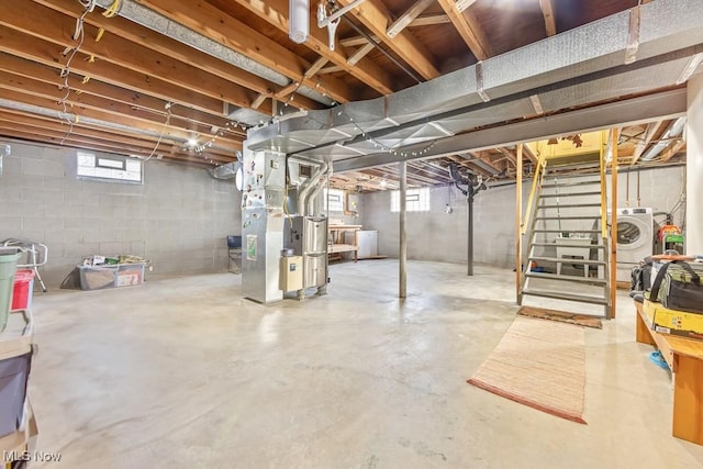 basement with heating unit and washer / clothes dryer