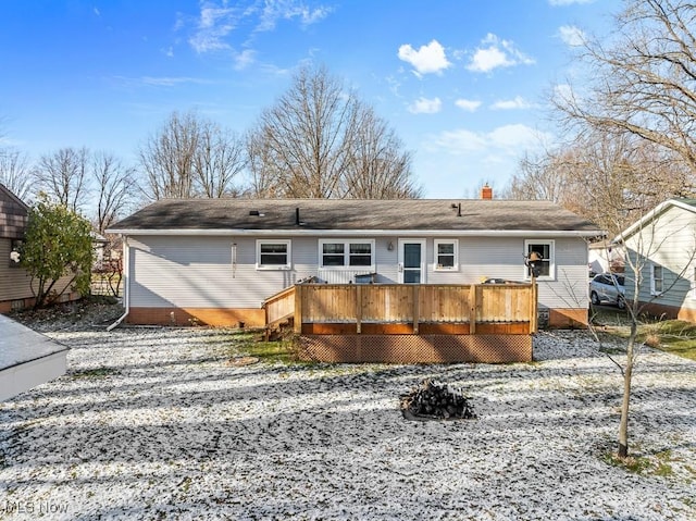 rear view of property with a wooden deck