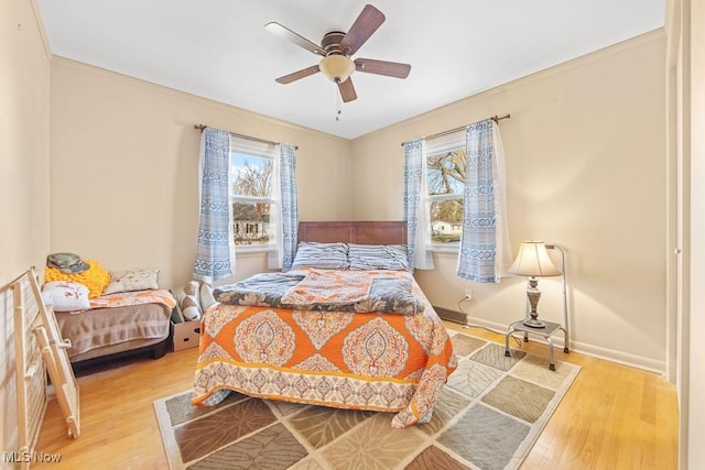 bedroom featuring light hardwood / wood-style flooring and ceiling fan