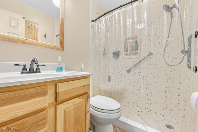 bathroom featuring a shower with shower curtain, tile patterned floors, vanity, and toilet