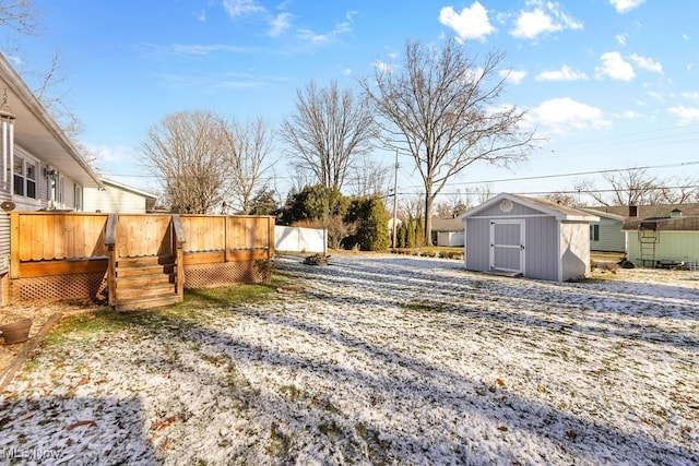 view of yard with a storage shed and a wooden deck