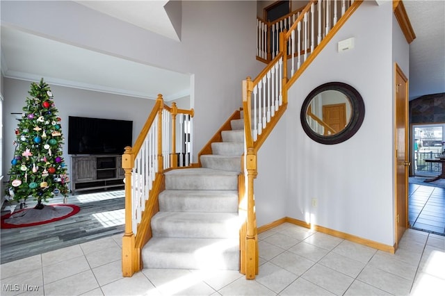 stairway with hardwood / wood-style floors and ornamental molding