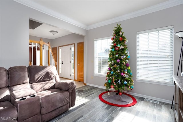 living room featuring hardwood / wood-style flooring and crown molding