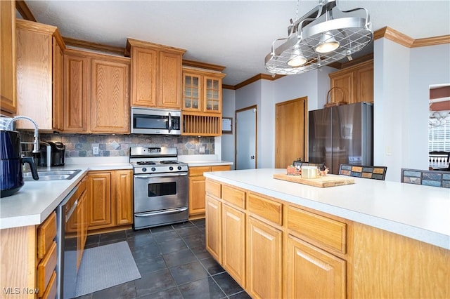 kitchen with sink, crown molding, pendant lighting, decorative backsplash, and appliances with stainless steel finishes