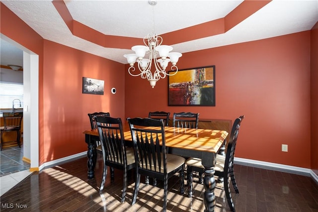 dining space with a chandelier and wood-type flooring