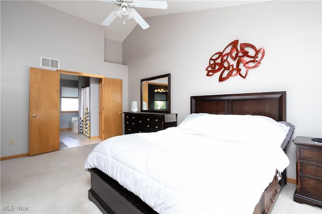 bedroom featuring ensuite bath, high vaulted ceiling, ceiling fan, and light colored carpet