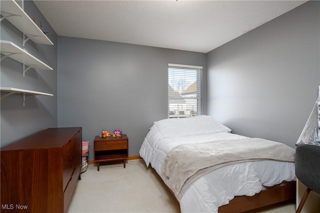 carpeted bedroom featuring a textured ceiling