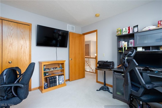 home office with carpet and a textured ceiling