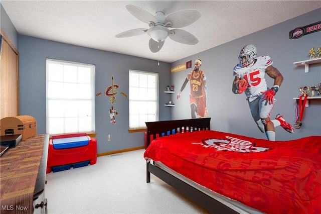 bedroom with ceiling fan, a closet, carpet floors, and a textured ceiling