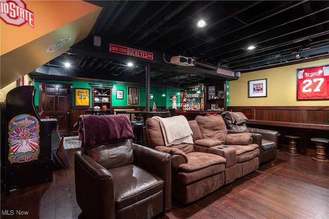 cinema featuring hardwood / wood-style floors and bar