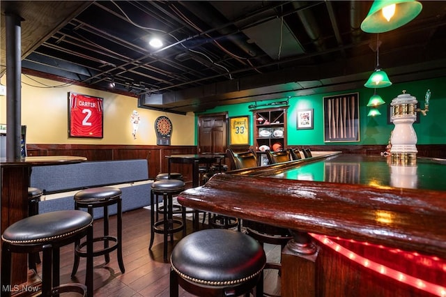 bar with hardwood / wood-style flooring