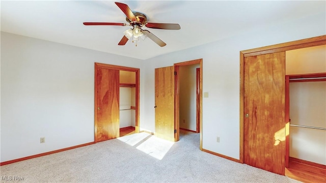 unfurnished bedroom featuring ceiling fan and light colored carpet