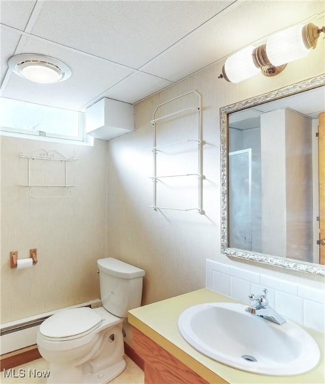 bathroom featuring decorative backsplash, vanity, and toilet