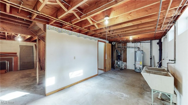 basement with gas water heater and sink