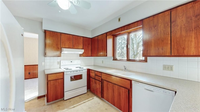 kitchen featuring decorative backsplash, ceiling fan, sink, and white appliances