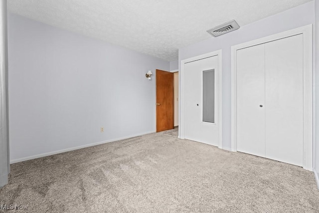 unfurnished bedroom with carpet and a textured ceiling