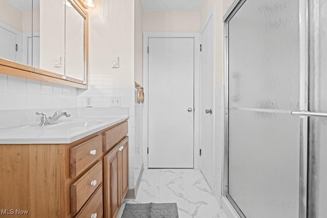 bathroom with vanity and a shower with door