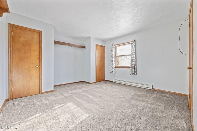 unfurnished bedroom with light carpet, a closet, and baseboard heating