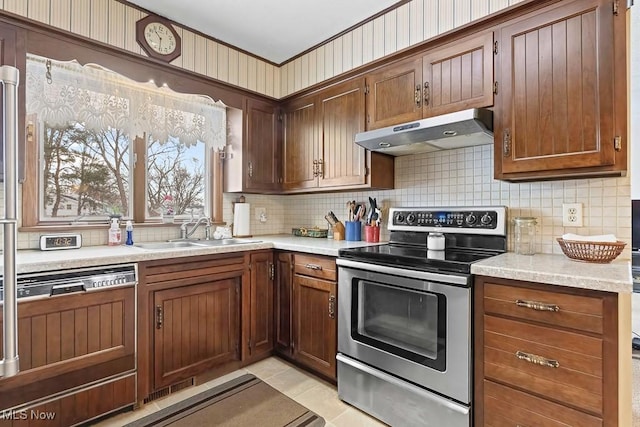 kitchen with stainless steel electric range oven, sink, dishwasher, backsplash, and light tile patterned floors