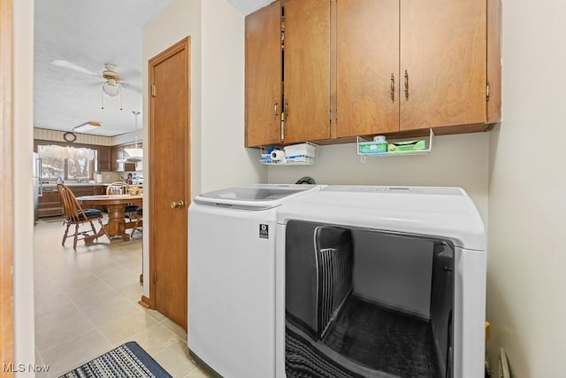 clothes washing area with cabinets, ceiling fan, independent washer and dryer, a textured ceiling, and light tile patterned floors