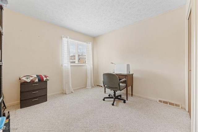 carpeted office space with a textured ceiling