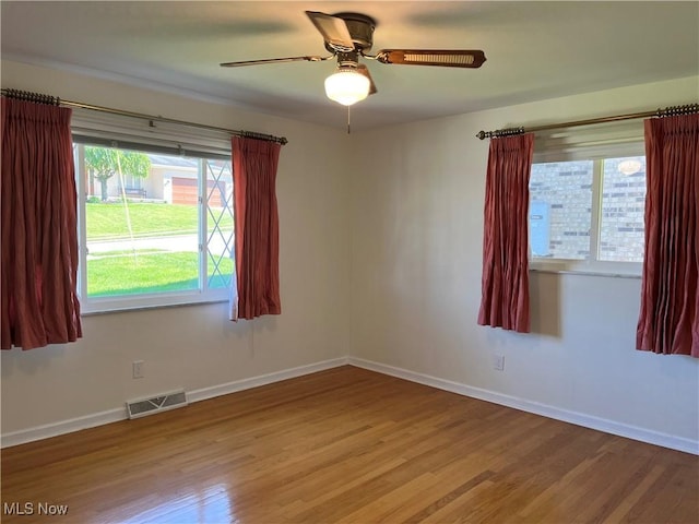 unfurnished room with hardwood / wood-style floors and ceiling fan