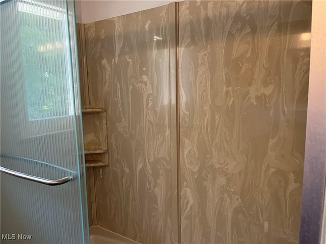 bathroom featuring a wealth of natural light and a shower with door