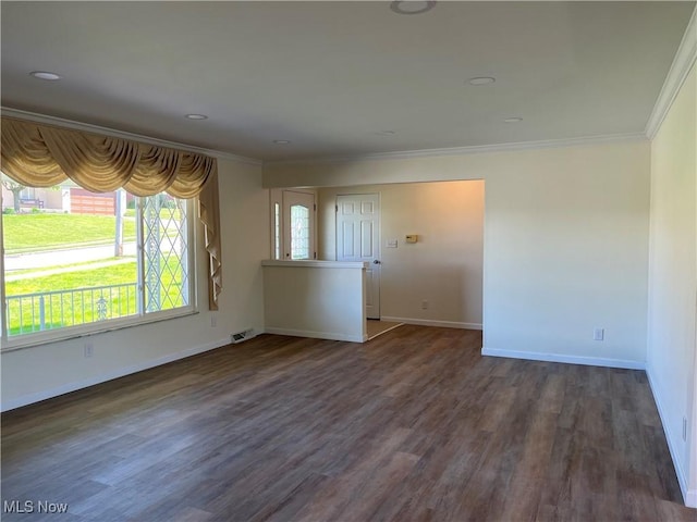 spare room featuring dark wood-type flooring and ornamental molding