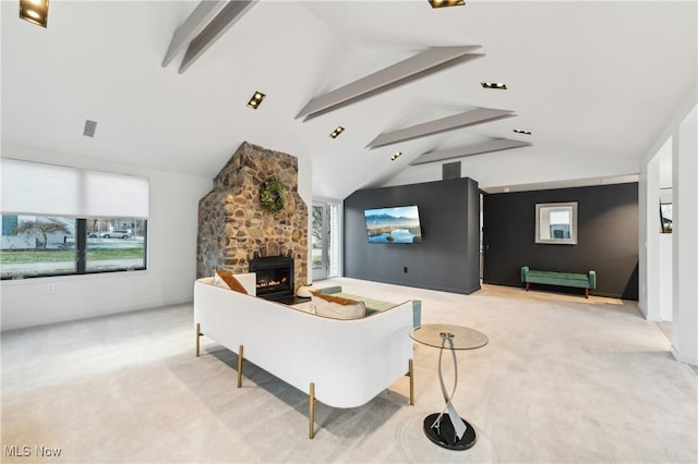 living room featuring lofted ceiling with beams, light colored carpet, and a wealth of natural light