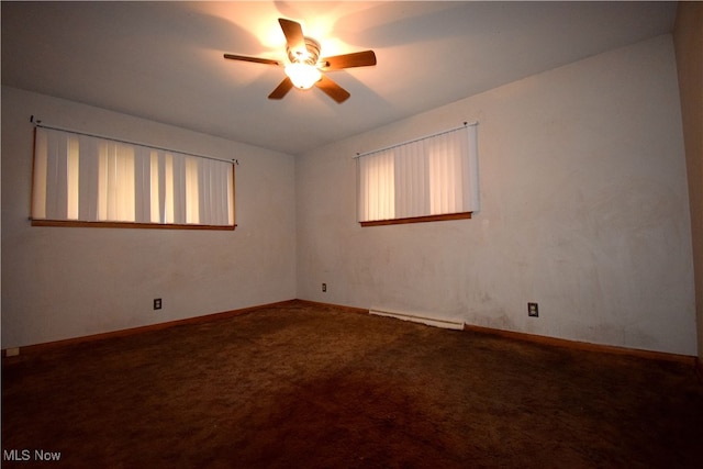 empty room with carpet flooring, ceiling fan, and baseboard heating