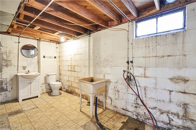 below grade area featuring light floors and a sink