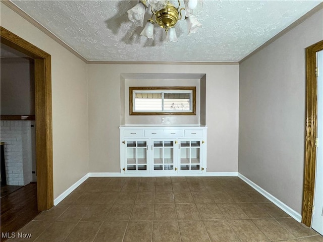 unfurnished living room with a fireplace, ornamental molding, and a textured ceiling