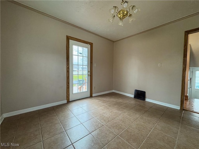 tiled empty room featuring an inviting chandelier and ornamental molding