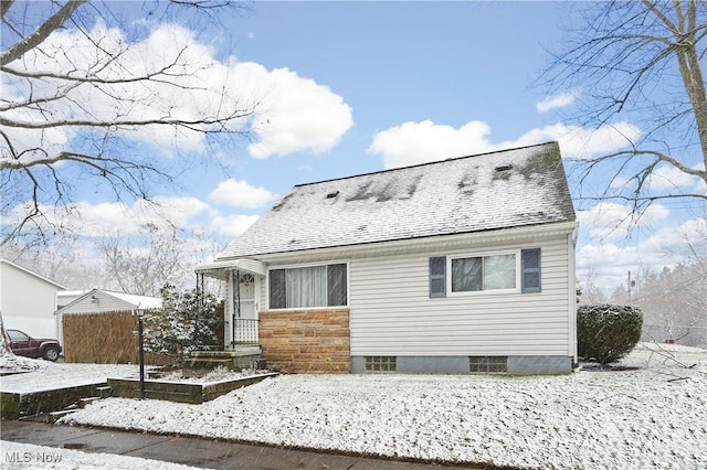 view of snow covered rear of property