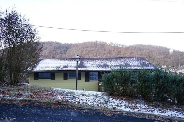 view of snowy exterior featuring a mountain view