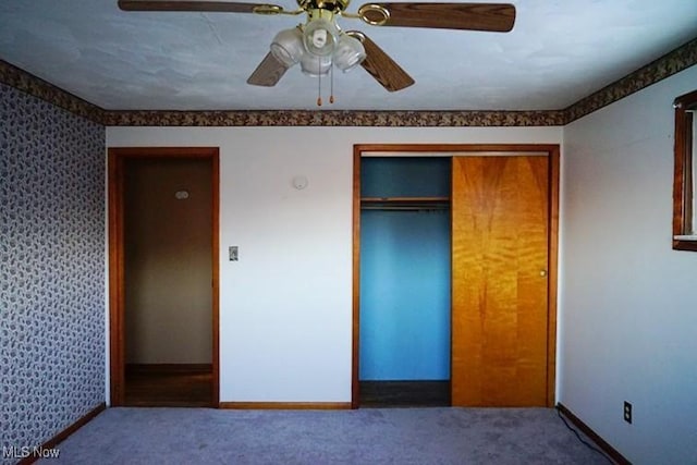 unfurnished bedroom featuring carpet, ceiling fan, and a closet