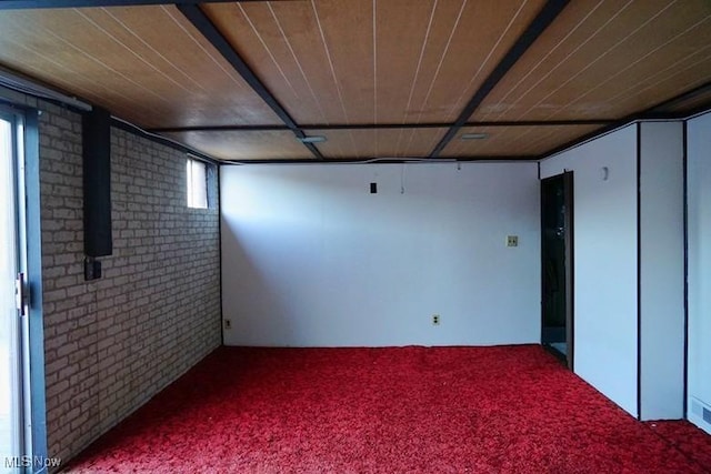 basement with carpet floors, brick wall, and wooden ceiling