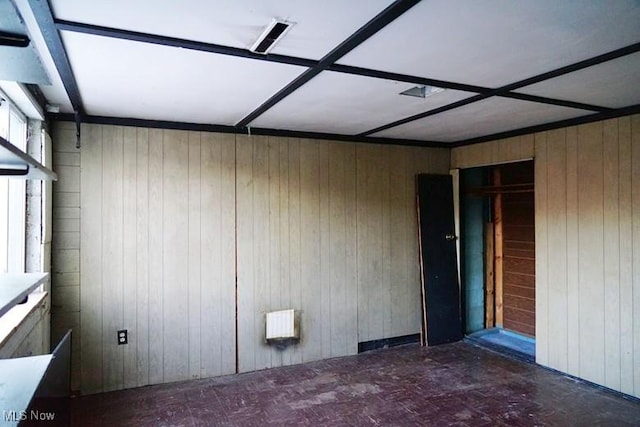 unfurnished room with wood walls