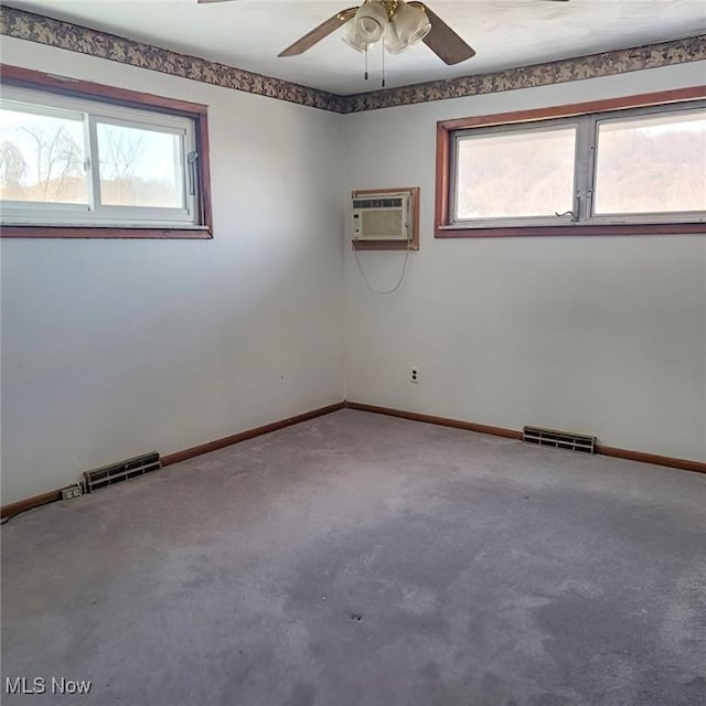 spare room with plenty of natural light, visible vents, and a wall mounted air conditioner