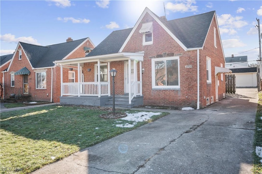 view of front of property with covered porch and a front yard