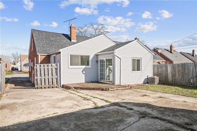 back of property with central AC and a patio area