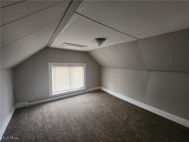 additional living space featuring carpet flooring, a baseboard radiator, and lofted ceiling